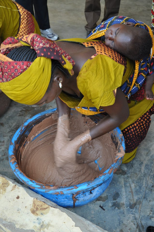 Catching a snooze while mama kneads shea butter