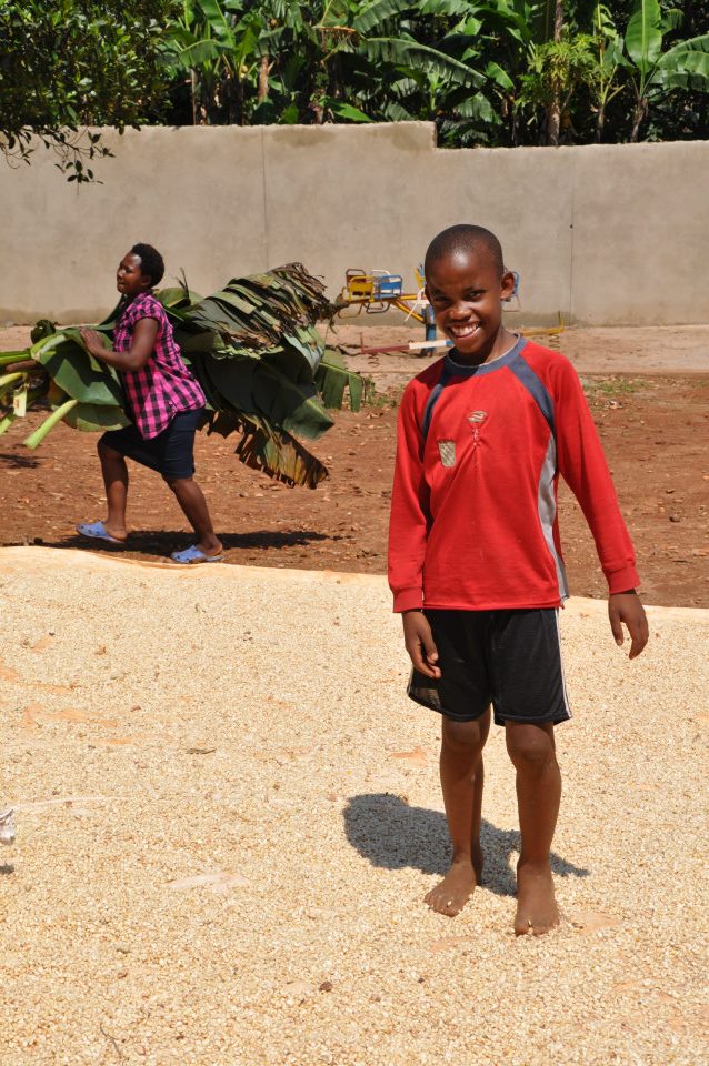 E playing in the maize at St. Noah's home