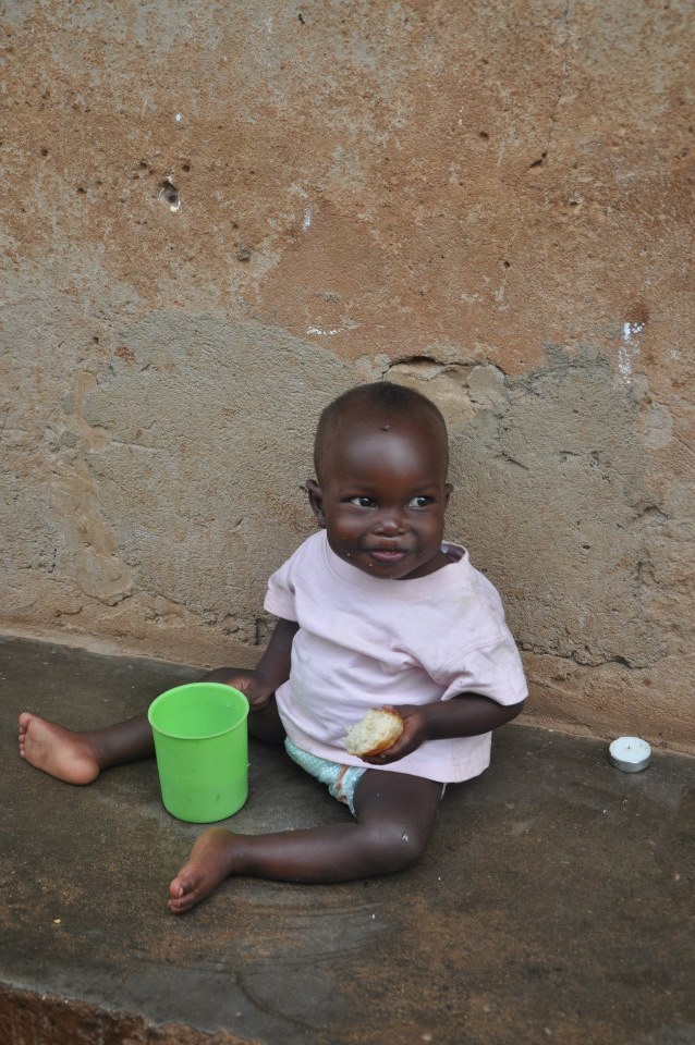 Baby C enjoying a lunch of posho + beans