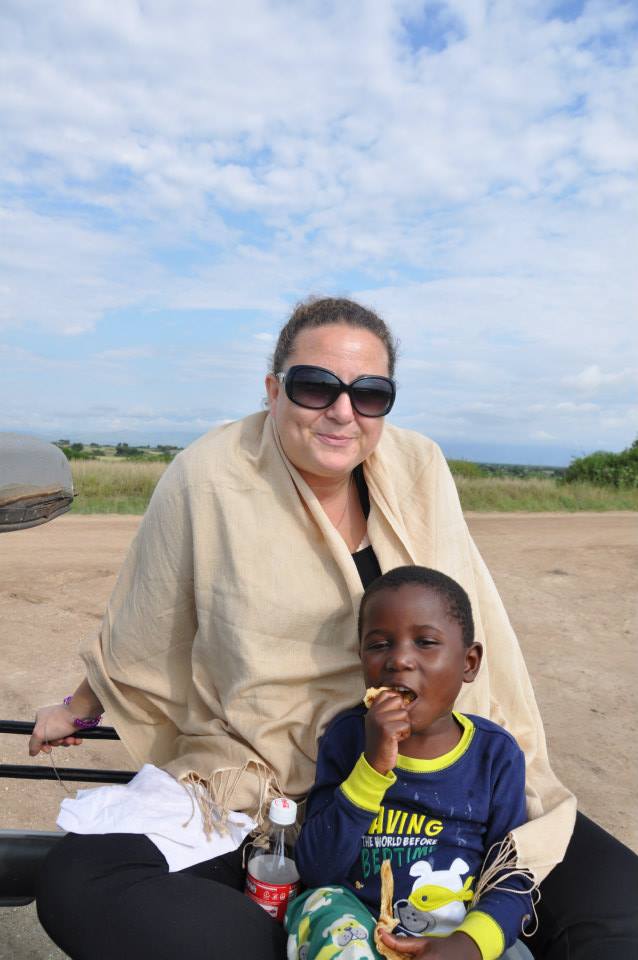 Enjoying a rooftop picnic with B, one of my favorite kids in all of Africa, while on safari in September 2013. Chapatti + Fanta = breakfast of champions