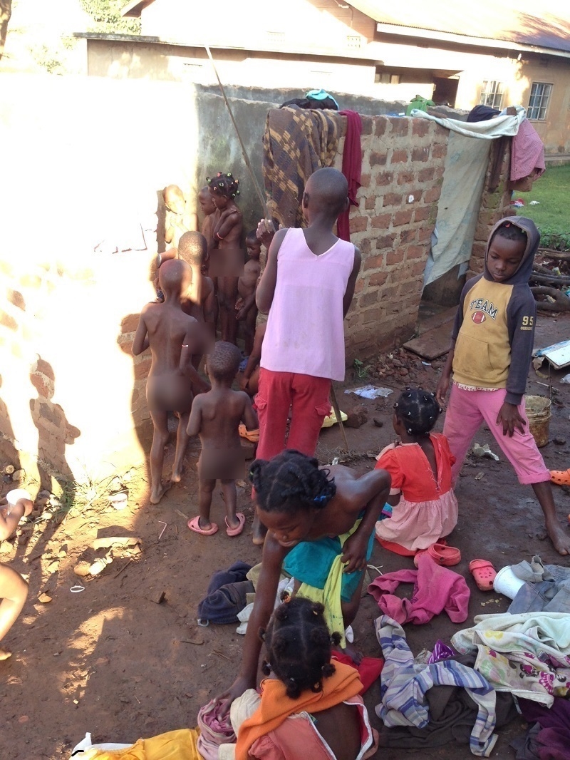 Outdoor, mixed company bathing at God's Grace Orphanage/ God's Grace Childcare Center